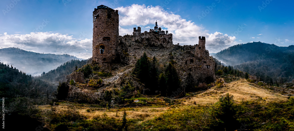 A lonely abandoned castle in the mountains with dramatic sky background. 3D illustration A lonely abandoned castle in the mountains with dramatic sky background. 3D illustration