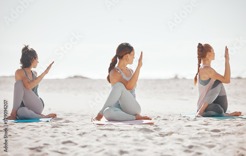 Obraz na płótnie Zen, heath and yoga group meditation on a beach with women training and meditating together