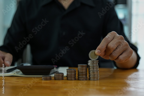 Man holding a piggy bank on a wooden table save money and financial ideas