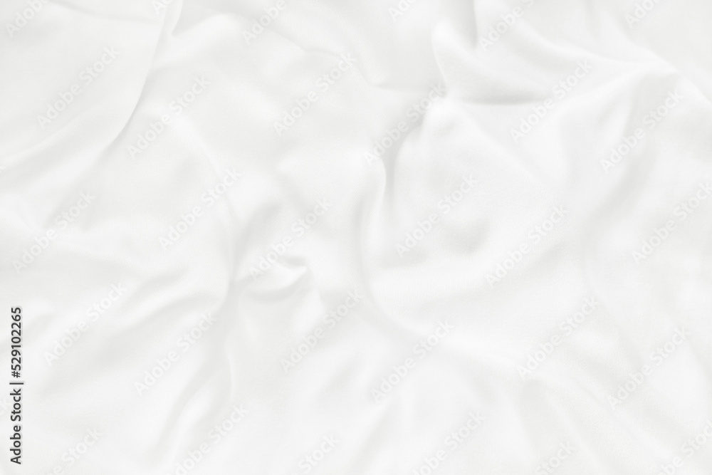 Close up top view of white bedding sheet and wrinkle messy blanket in bedroom after wake up in the morning.