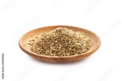 dry oregano in wood plate isolated on white background. dry oregano in a wood bowl isolated on white background.                          