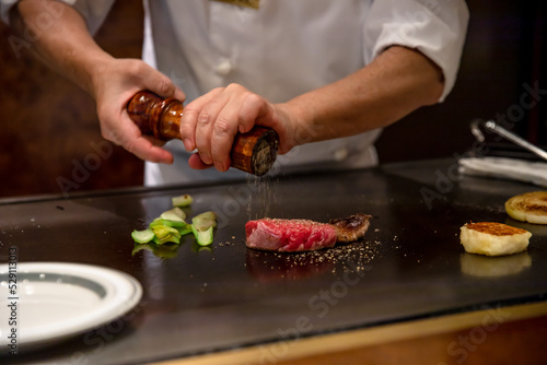 Fotografía 鉄板焼きステーキを料理人が調理している