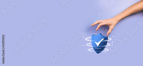 Businessman hold low poly polygon shield with a tick icon.Secure Access System Concept.Business Financial Warranty for Investment.antivirus concept.Technology security.Protection network,safe data.