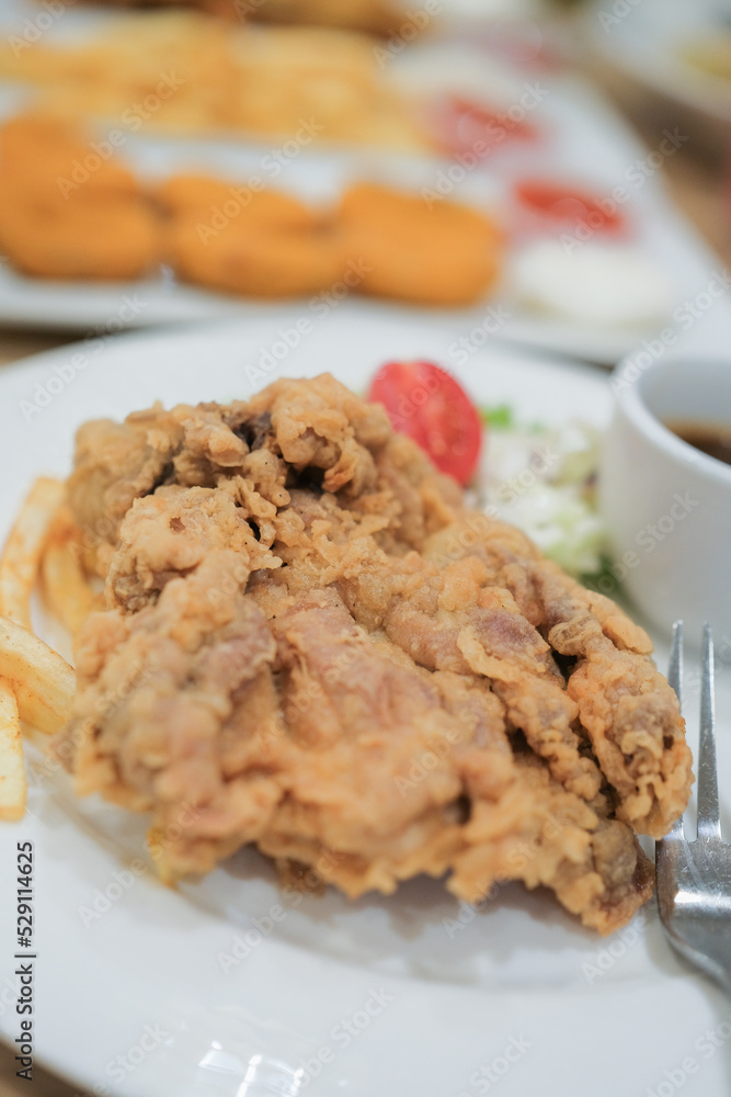 A plate of chicken chop set come with french fries , coleslaw and carrot milk ice A plate of chicken chop set come with french fries , coleslaw and carrot milk ice