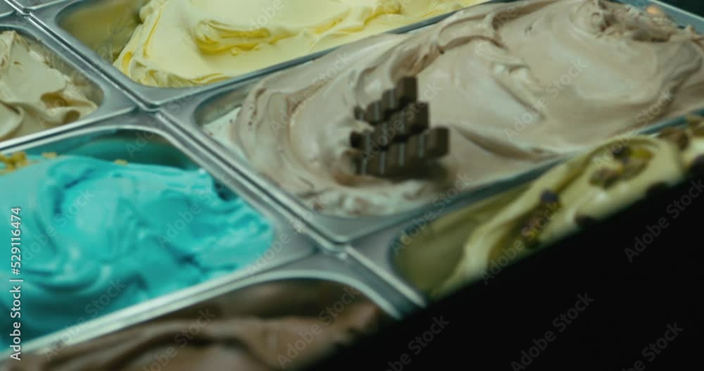 Putting a mango gelato ice cream tray in a showcase Putting a mango gelato ice cream tray in a showcase