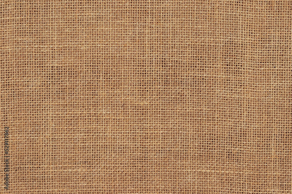 Brown burlap cloth background or sack cloth for packing. Natural linen threads texture. Sackcloth, empty space. Wrapping detail, old grainy cotton backdrop close-up. Brown burlap cloth background or sack cloth for packing. Natural linen threads texture. Sackcloth, empty space. Wrapping detail, old grainy cotton backdrop close-up.