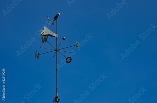 wind rose and weather vane on the blue sky