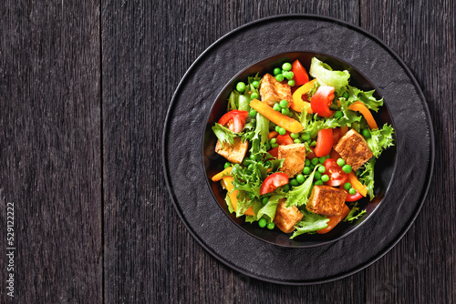tofu salad with greens and vegetables in bowl