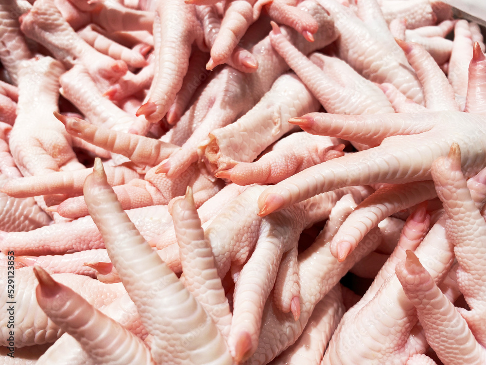 Raw chicken feet are fresh and are sold in the fresh market , Thailand