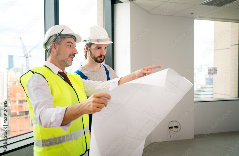 Construction engineer with foreman worker checking construction site Construction engineer with foreman worker checking construction site