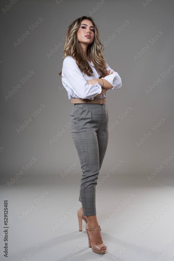 Full body of a young businesswoman on gray Full body of a young businesswoman on gray