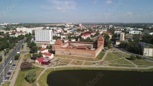 Aerial shot circulating a famous castle in lida city of belarus on partly cloudy day photo