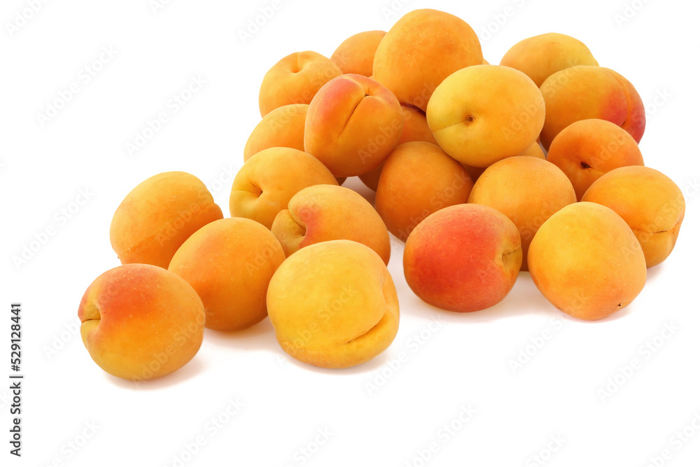 The pile of scattered apricots isolated on white background The pile of scattered apricots isolated on white background