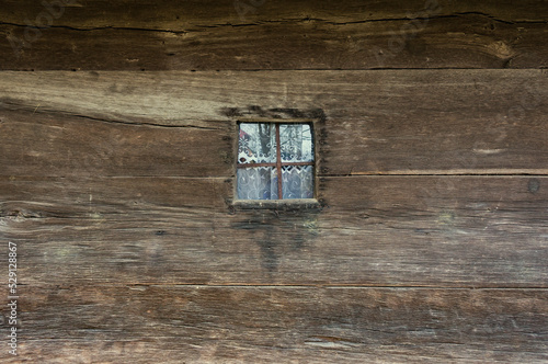 Window in an old wooden house. Texture of ancient architecture