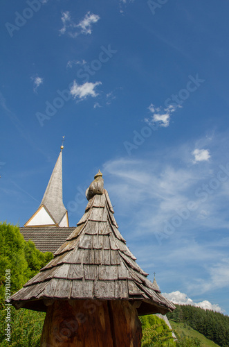 Wooden roof  church and blue sky  copy space  at austrian village Sankt Michael im Lungau  vertical 