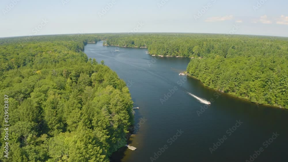 Aerial view flying over a jet ski on a beautiful river on a summer day. Drone view. Muskoka, Ontario, Canada. Aerial view flying over a jet ski on a beautiful river on a summer day. Drone view. Muskoka, Ontario, Canada.
