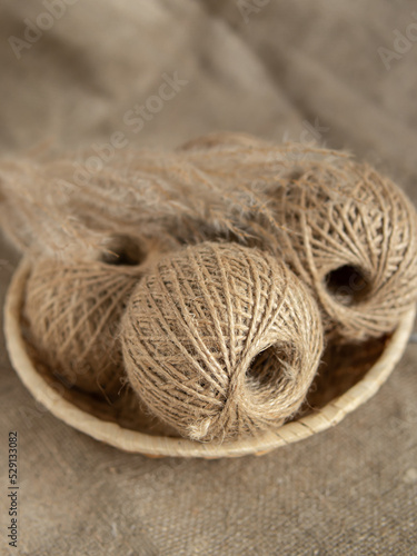 Tangles of jute twine threads in basket. Natural. Yarn for needlework. Vertical