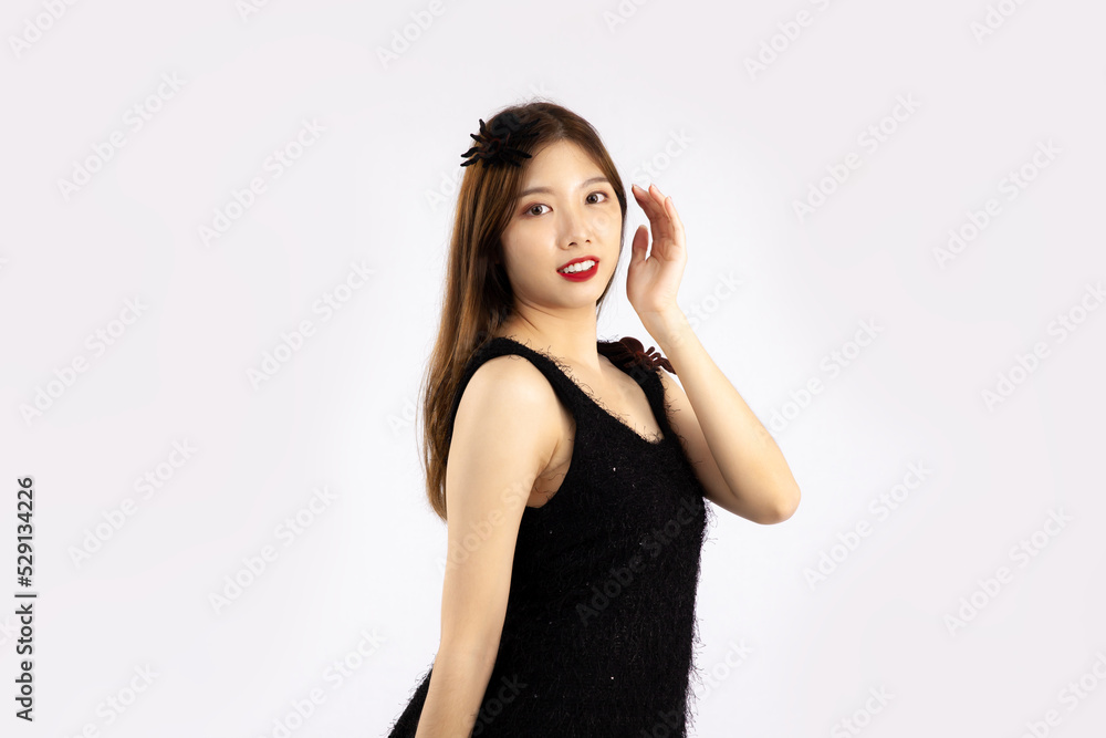 Young pretty asian woman long hair style in black dress posing on white background. Young pretty asian woman long hair style in black dress posing on white background.