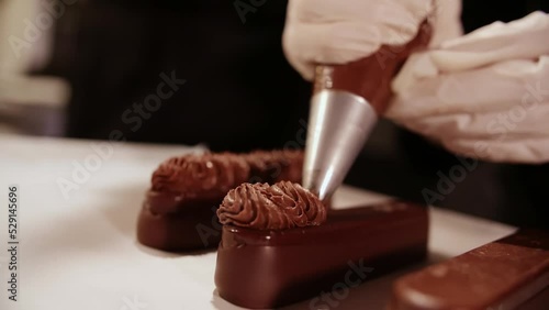 Brownie dessert is filled with cream.The process of making Brownie dessert.Chef prepares the long chocolate desserts.Close-Up