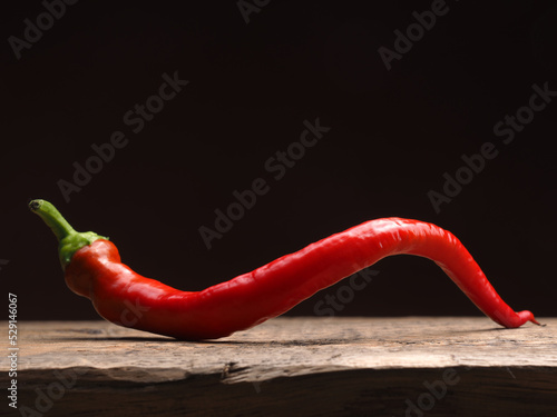 Fotobehang Spicy organic red chili pepper on a rustic wooden table, food ingredients, space