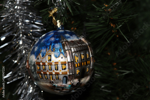 Christmas ball on an artificial tree with tinsel