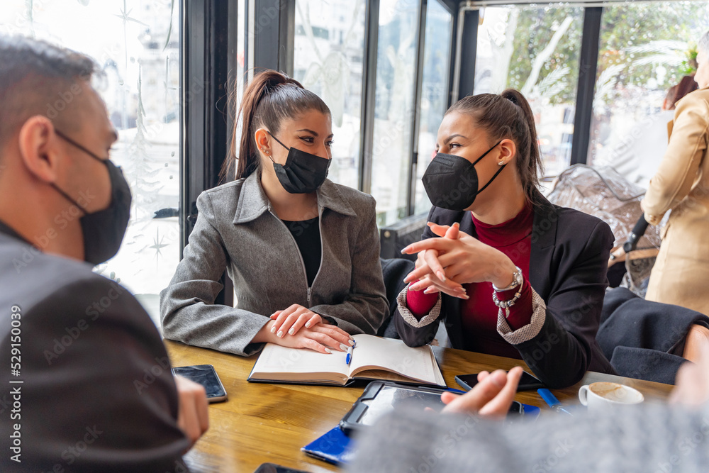 Fototapeta premium Discussing the plans and ideas for the company, covid masks