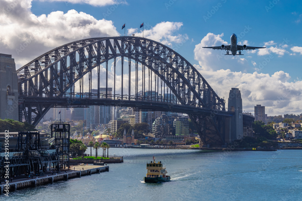 Plane flying over Sydney Harbour Sydney NSW Australia. 