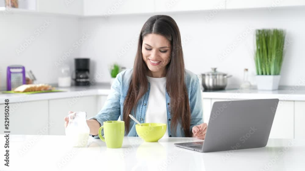 Lady sit kitchen table have wheat yummy organic breakfast watch video netbook Lady sit kitchen table have wheat yummy organic breakfast watch video netbook