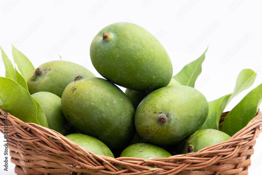 Fresh Green Raw Mango Also Called Aam, Kairi In Tradition Indian Wooden Basket Has Multiple Health Benefits, Is Rich Source Of Vitamins. Used For Chutney, Khatta Aam Panna And Aam Ka Achar Pickle
