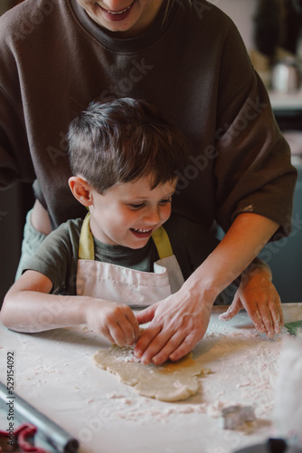 mother and son preparing flour for cookies in the kitchen