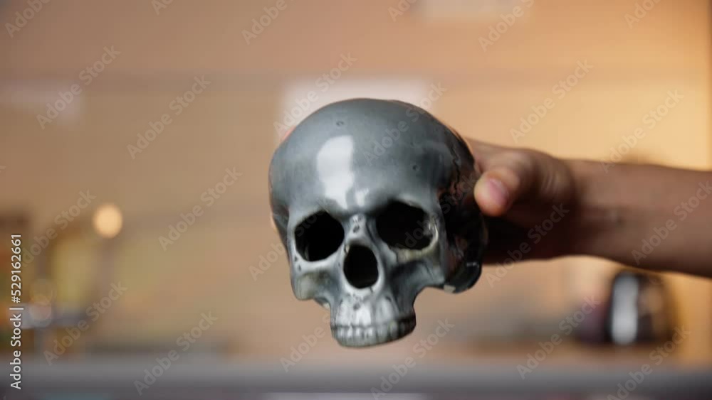 Skull in his hand on a defocused background. Halloween concept Skull in his hand on a defocused background. Halloween concept