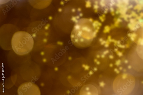 Abstract background with gold bokeh and blur star sparkles particles a Holiday, wedding , cosmetic backdrop.Banner , copy space