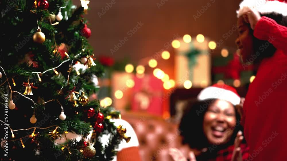 Father mother and daughter decorations christmas tree together for xmas festival in upcoming. Father mother and daughter decorations christmas tree together for xmas festival in upcoming.