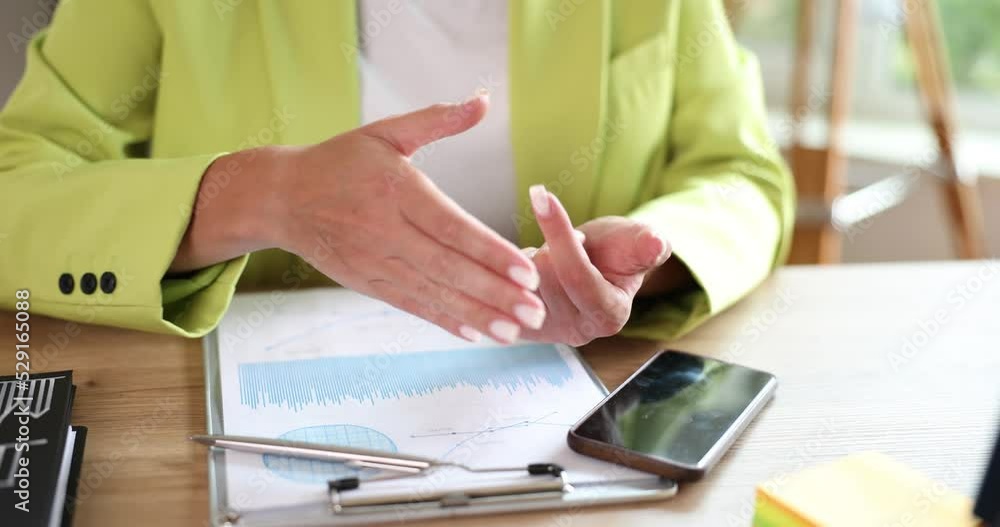 Business woman counts numbers in document and sums up on fingers closeup Business woman counts numbers in document and sums up on fingers closeup