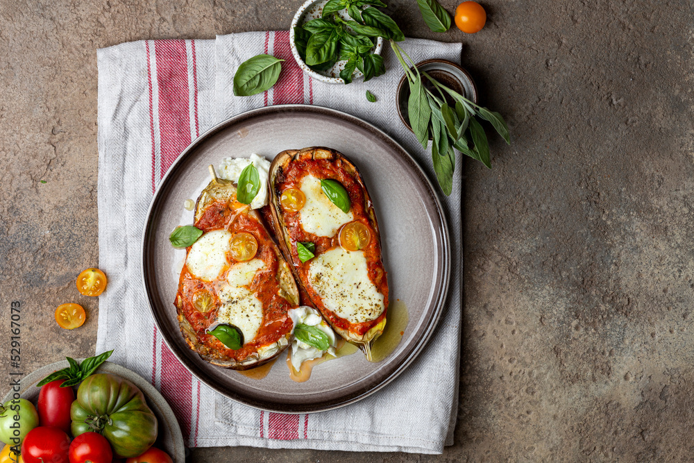 Baked eggplant with mozzarella cheese, tomatoes and basil Stock Photo