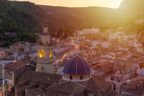 Fotobehang Old Spanish city with the dome and the tower of its church in the evening light