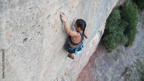 Female climber climbing a hard and steep section of the wall in Sant Llorenç del Munt y l'Obac Natural Park, Catalonia, Spain.
Following camera movement, low angle, 4K. photo