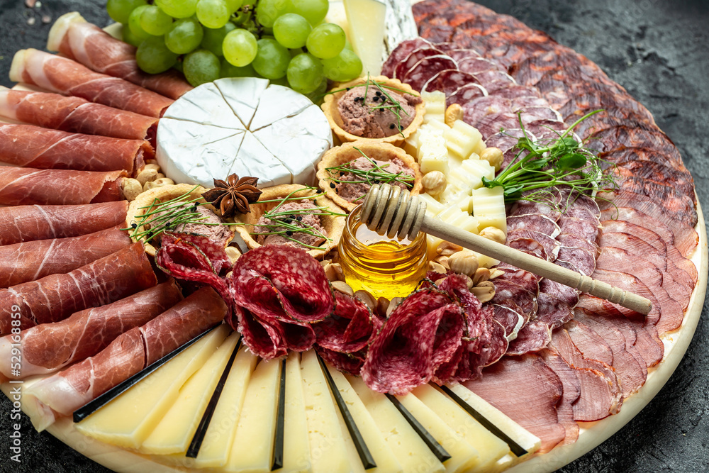 Antipasto platter of various types of soft and hard cheese. spanish