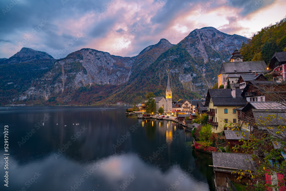 Amazing nightfall over Hallstatt. Scenic view of famous Hallstatt mountain village under picturesque moving clouds after sunset. UNESCO World Heritage, Hallstatt-Dachstein, Salzkammergut, Austria