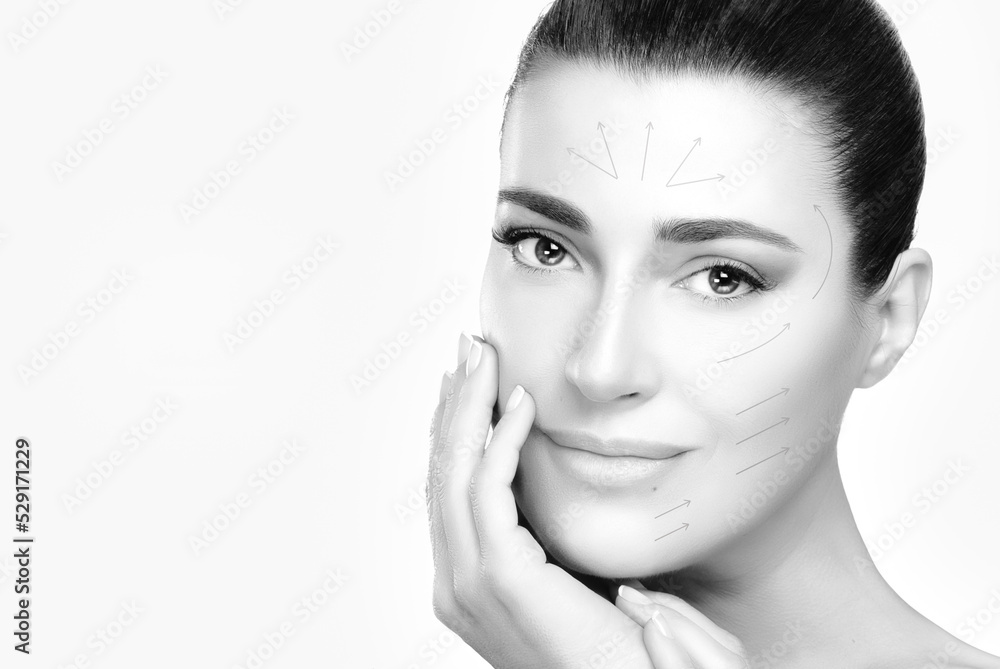 Surgery and Anti Aging Concept. Monochrome beauty face spa woman with lifting arrows draw over face. isolated on white with copy space Surgery and Anti Aging Concept. Monochrome beauty face spa woman with lifting arrows draw over face. isolated on white with copy space