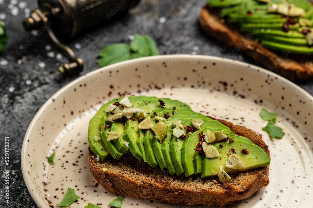 toasts with avocado, rye bread, sliced avocado. Vegetarian Vegan menu, recipe. Delicious breakfast or snack, Clean eating, dieting, vegan food concept. top view toasts with avocado, rye bread, sliced avocado. Vegetarian Vegan menu, recipe. Delicious breakfast or snack, Clean eating, dieting, vegan food concept. top view