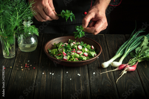 Professional chef prepares a salad of fresh vegetables. The idea of a diet breakfast or dinner