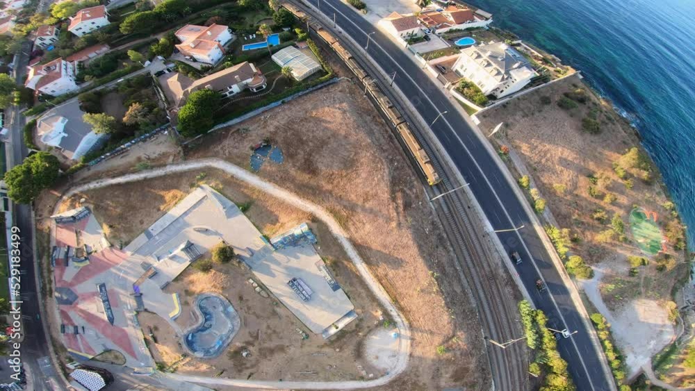 Aerial of large skate park across from downtown Lisbon with train crossing the line. sunny day with amazing colors. Aerial of large skate park across from downtown Lisbon with train crossing the line. sunny day with amazing colors.