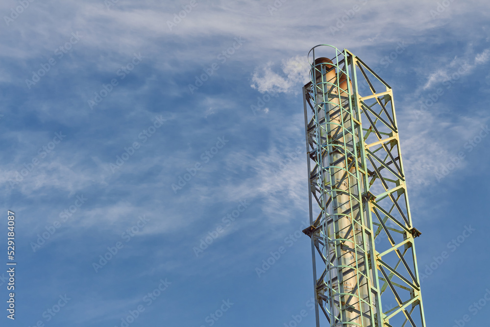Industrial pipe. Metal frame. A long, tall metal pipe. Background of sky. Industrial pipe. Metal frame. A long, tall metal pipe. Background of sky.