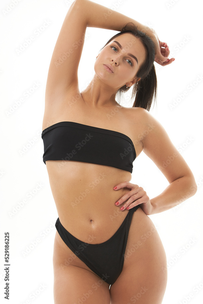 Healthy girl with toned slim body, soft skin and elastic buttocks, thighs  in black bikini panties, sexy back, narrow big ass in underwear. Beautiful  female body in shape. ภาพถ่ายสต็อก