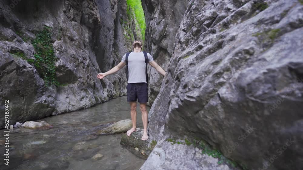 Free and peaceful young man in the creek in the canyon.
Coming out of the stream, the young man opens his hands and takes a deep breath. He is peaceful and happy.
Free and peaceful young man in the creek in the canyon.
Coming out of the stream, the young man opens his hands and takes a deep breath. He is peaceful and happy.