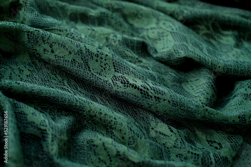 Green genuine leather and lace, fashion abstract background, top view photo