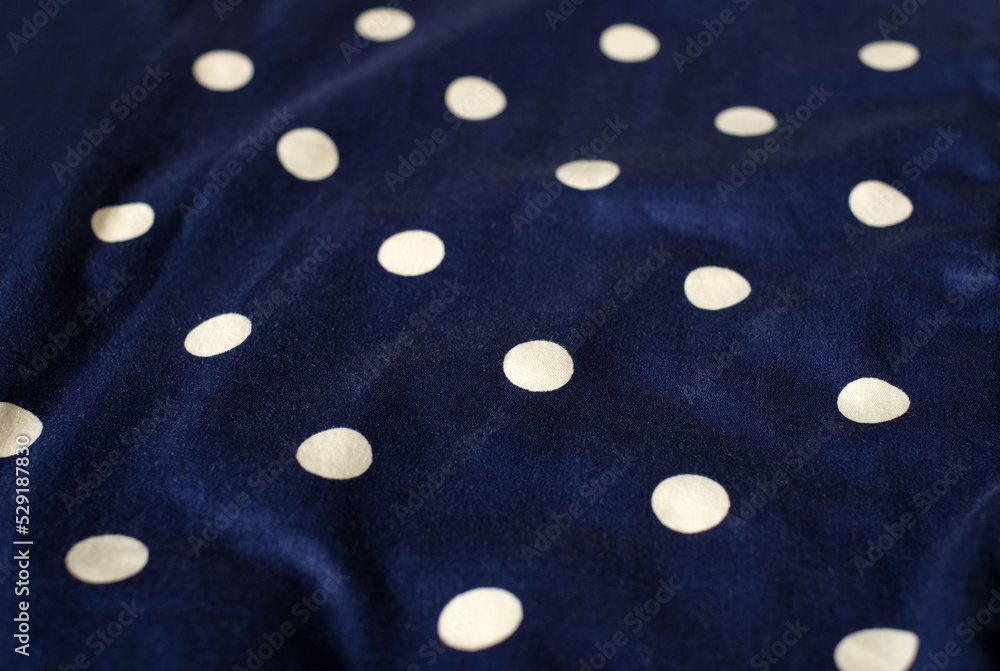 Dark blue cotton polka dots fabric textile, top view Dark blue cotton polka dots fabric textile, top view