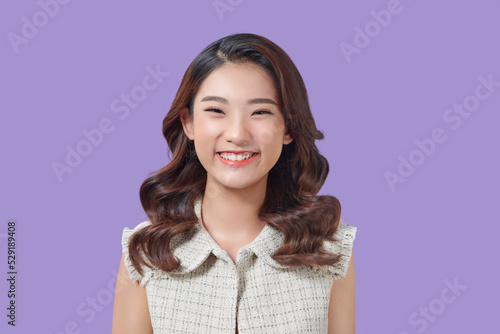 Portrait of happy and positive woman close eyes  smiling carefree on purple background.