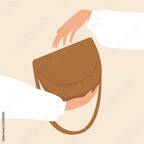 Woman's hands holds a beige bag